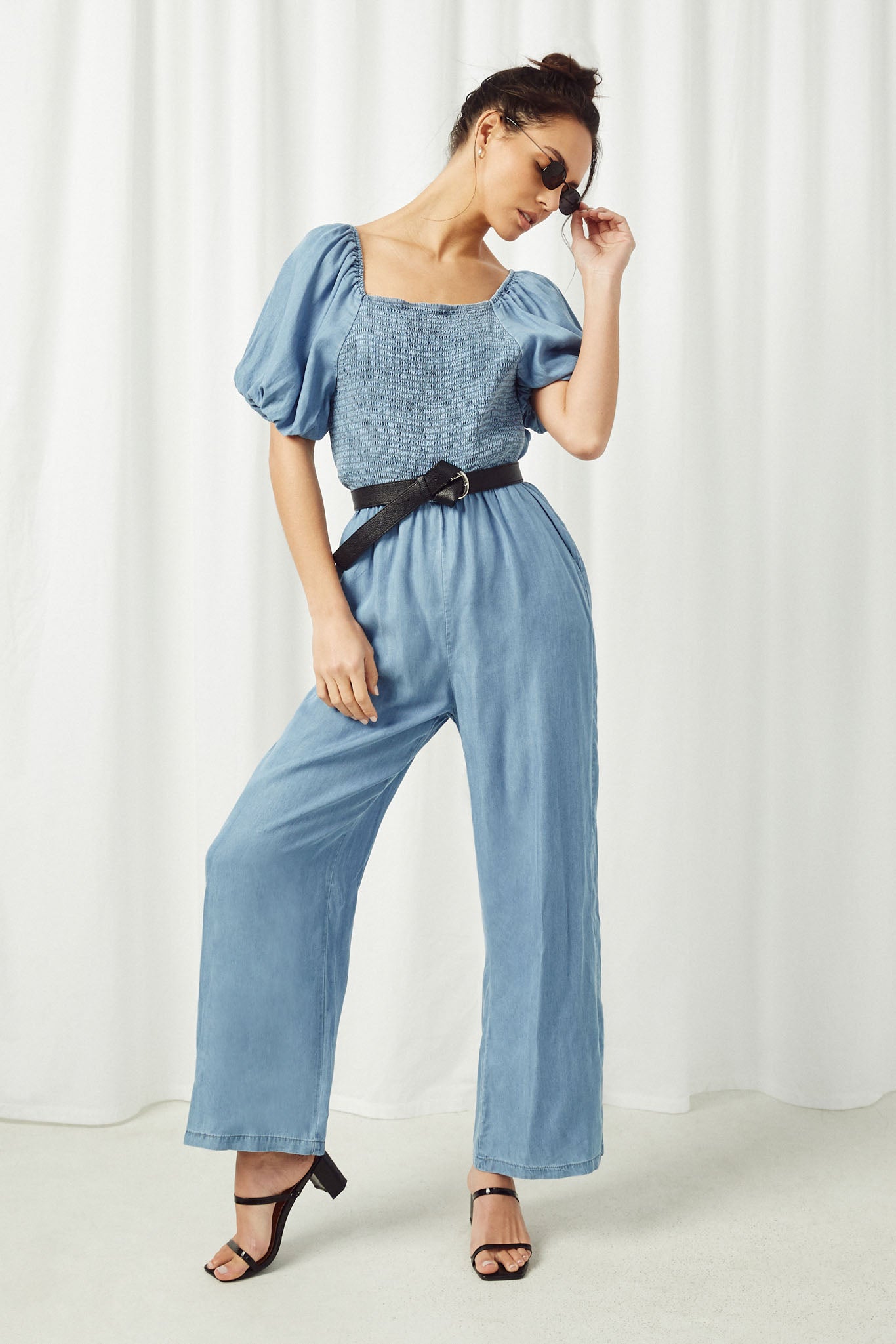 HY2567 Dark Denim Womens Smocked Puff Sleeve Tencel Jumpsuit Pose