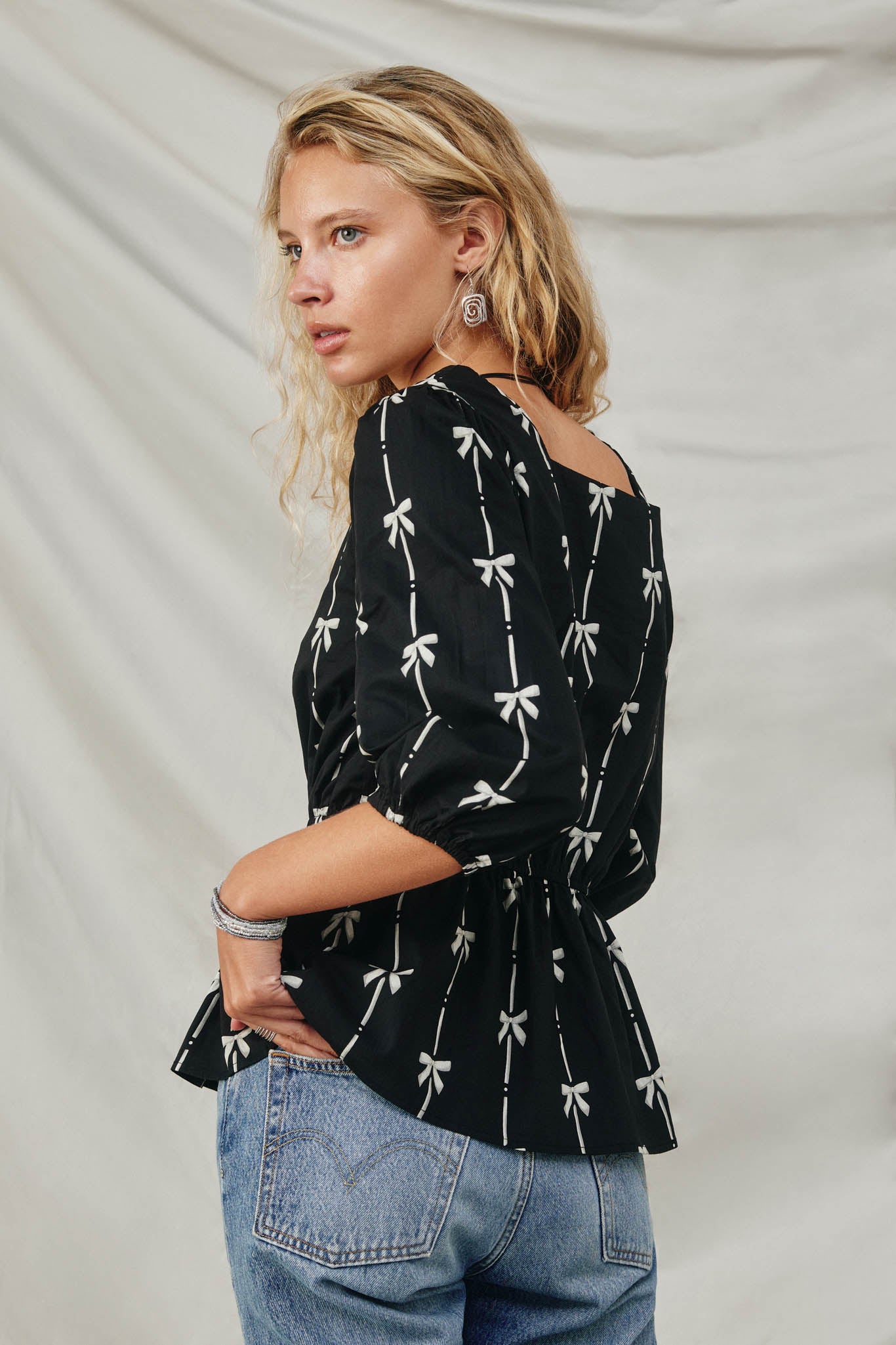 HY8871 Black Womens All Over Bow Print Peplum Top Pose