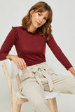 H6452 Wine Womens Ribbed Ruffle Mock Neck Top Sitting Pose
