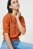 H7939 Pumpkin Lace Smock Waist Top Sitting Pose